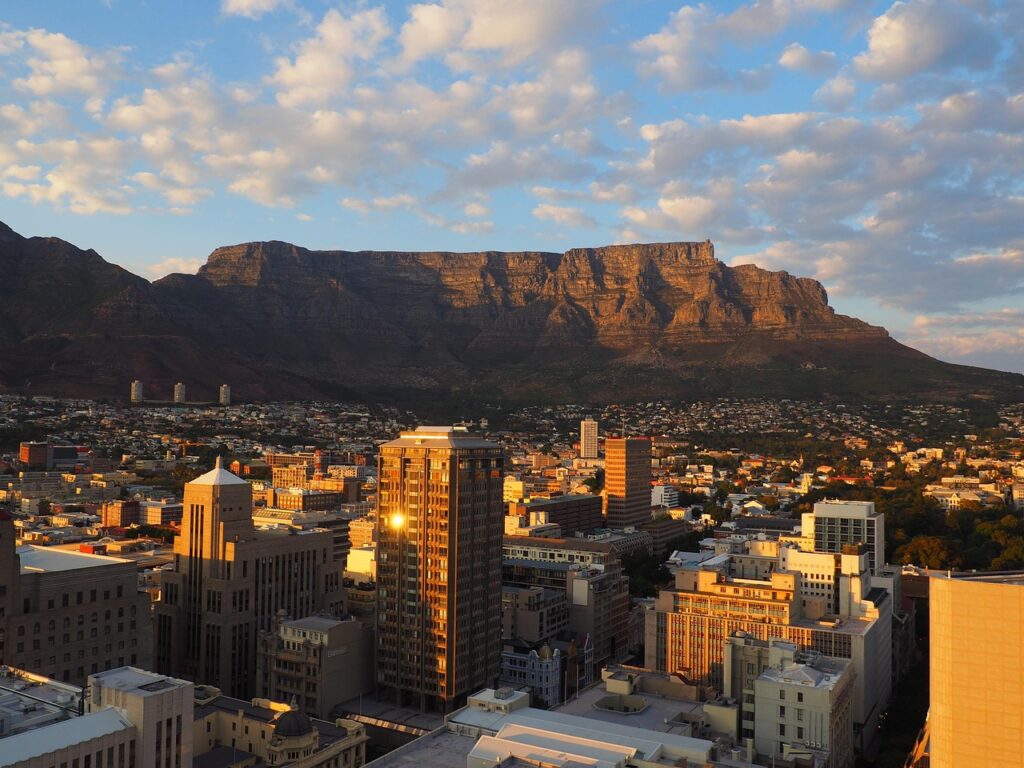 Informal housing spreads alongside a rapidly growing African city skyline.